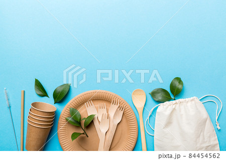 set of empty reusable disposable eco-friendly plates, cups, utensils on light white colored table background. top view. Biodegradable craft dishes. Recycling concept. Close-up set of empty reusable disposable eco-friendly plates, cups, utensils on light white colored table background. top view. Biodegradable craft dishes. Recycling concept. Close-up 84454562