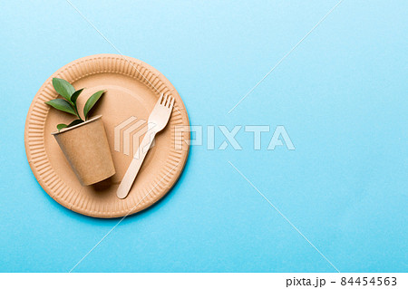 set of empty reusable disposable eco-friendly plates, cups, utensils on light white colored table background. top view. Biodegradable craft dishes. Recycling concept. Close-up 84454563