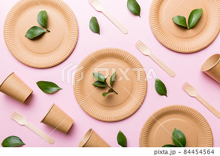set of empty reusable disposable eco-friendly plates, cups, utensils on light white colored table background. top view. Biodegradable craft dishes. Recycling concept. Close-up 84454564