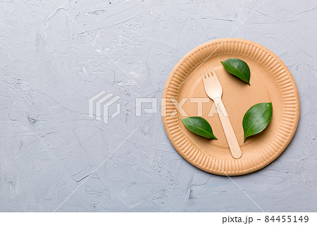set of empty reusable disposable eco-friendly plates, cups, utensils on light white colored table background. top view. Biodegradable craft dishes. Recycling concept. Close-up 84455149