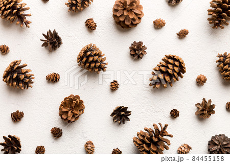 pine cones on colored table. natural holiday background with pinecones grouped together. Flat lay. Winter concept pine cones on colored table. natural holiday background with pinecones grouped together. Flat lay. Winter concept 84455158