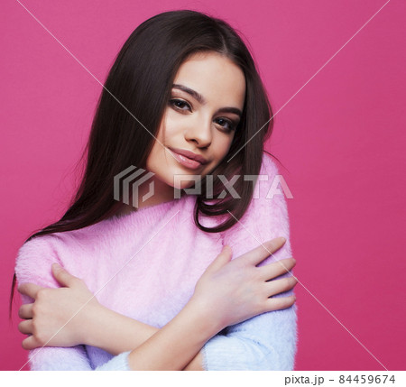 young pretty girl with brunette long hair posing cheerful on pink background, lifestyle people concept young pretty girl with brunette long hair posing cheerful on pink background, lifestyle people concept 84459674