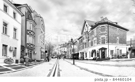 Panorama of the pedestrian street Kurortny prospect in Zelenogradsk, Russia, black and white photo 84460104
