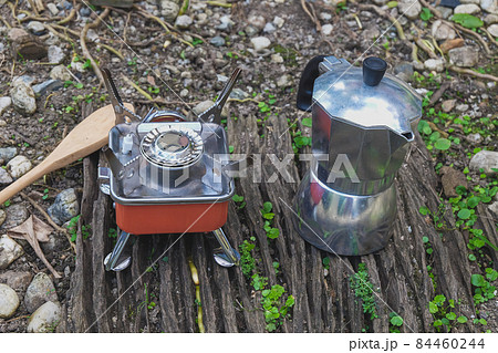 Moka pot coffee maker with Small stove on a mountain day. Moka pot coffee maker with Small stove on a mountain day. 84460244
