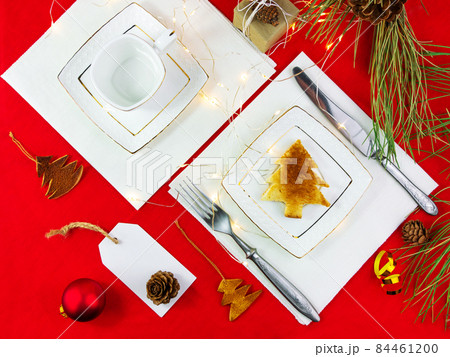 Christmas table setting toast white plate silverware red tablecloth background New year restaurant dinner decoration Christmas table setting toast white plate silverware red tablecloth background New year restaurant dinner decoration 84461200