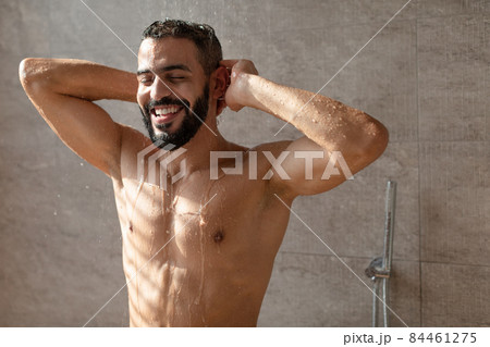 Handsome young Arabic male model enjoying taking hot shower Handsome young Arabic male model enjoying taking hot shower 84461275