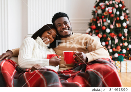 Portrait of happy black family watching tv on Xmas eve 84461390