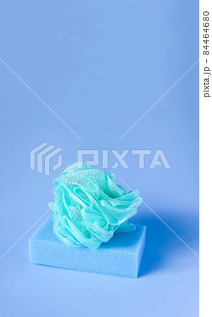 Colorful washcloths on a blue background. Accessories for body care and hygiene. Colorful washcloths on a blue background. Accessories for body care and hygiene. 84464680