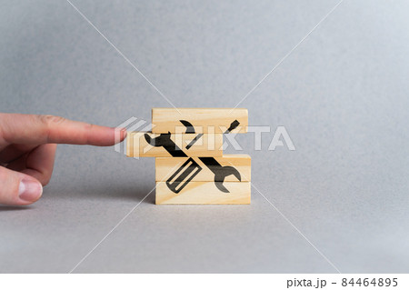 Concept for creating customer service and support from screwdriver and wrench icons and wooden blocks. Concept for creating customer service and support from screwdriver and wrench icons and wooden blocks. 84464895