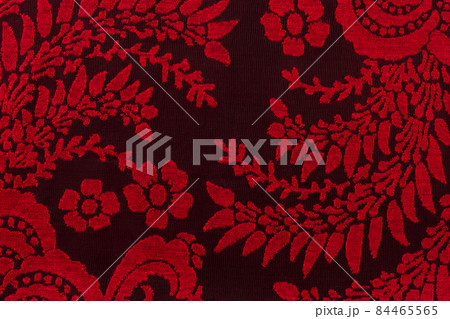 Red lace fabric with floral pattern against black bacground. Texture of embroidery red guipure. Red lace fabric with floral pattern against black bacground. Texture of embroidery red guipure. 84465565
