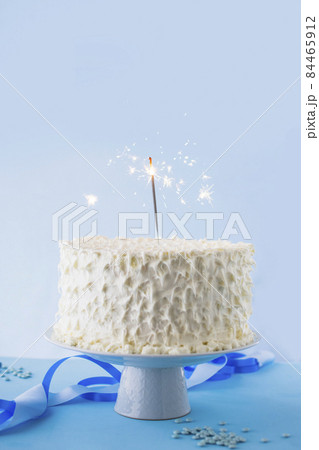white birthday cake with burning sparkler. High quality photo 84465912