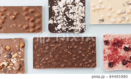 top view chocolate bars with nuts berries. High quality photo 84465980