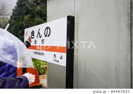 雨の秘境駅巡り、飯田線金野駅の駅名標に触れる観光客 雨の秘境駅巡り、飯田線金野駅の駅名標に触れる観光客 84467635