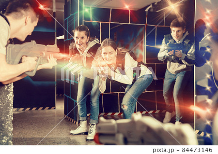 Young women having fun on dark lasertag arena Young women having fun on dark lasertag arena 84473146