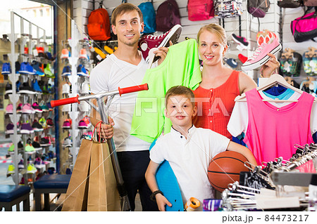 Happy friendly parents with boy in sport store Happy friendly parents with boy in sport store 84473217