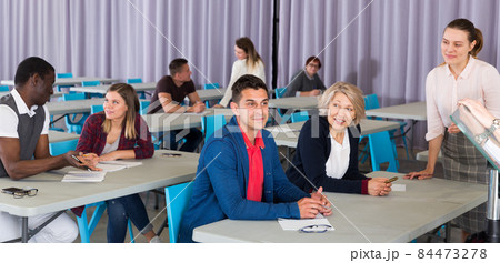 Adult students discussing lesson 84473278