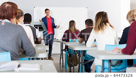 Male teacher lecturing to students Male teacher lecturing to students 84473328