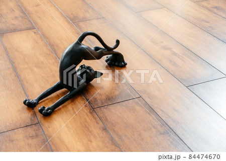 Ceramic black cat figurine bending doing yoga pose Ceramic black cat figurine bending doing yoga pose 84474670