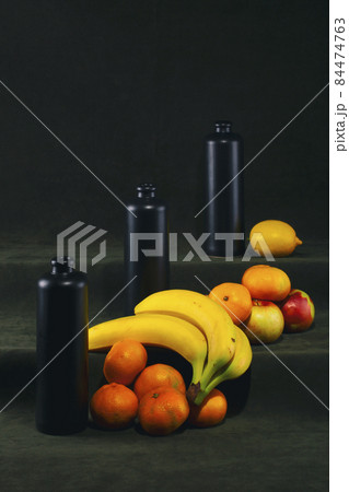Still life with black bottles and fruits Still life with black bottles and fruits 84474763
