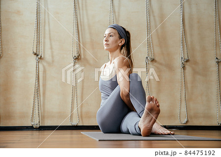 Young beautiful woman practicing yoga in yoga studio. Harmony, balance, meditation, relaxation, healthy lifestyle concept Young beautiful woman practicing yoga in yoga studio. Harmony, balance, meditation, relaxation, healthy lifestyle concept 84475192