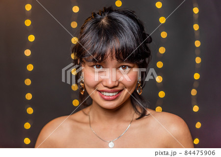 An asian woman smiling looking at camera with blurred background An asian woman smiling looking at camera with blurred background 84475906