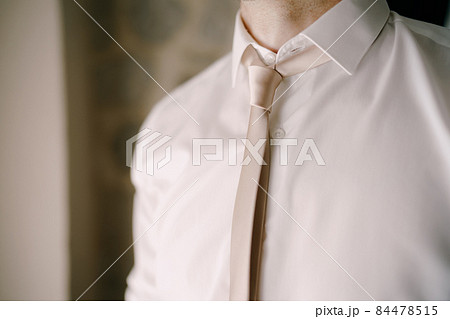 Man in a tie and white shirt. Close-up Man in a tie and white shirt. Close-up 84478515