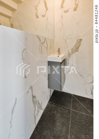 Small mixer in the corner of the room with a small sink Small mixer in the corner of the room with a small sink 84481246