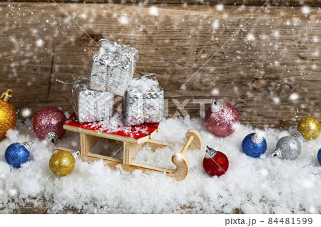 Silver boxes with gifts for a sled in the snow. 84481599