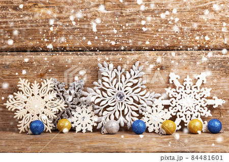 Border from snowflakes on an old wooden background. 84481601
