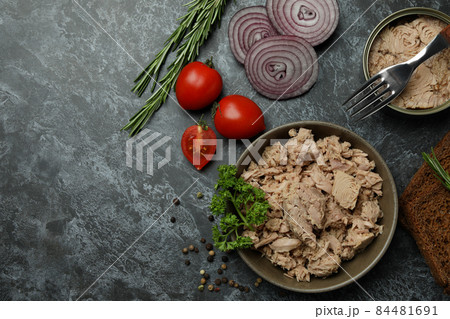 Concept of tasty eating with canned tuna on black smokey background Concept of tasty eating with canned tuna on black smokey background 84481691