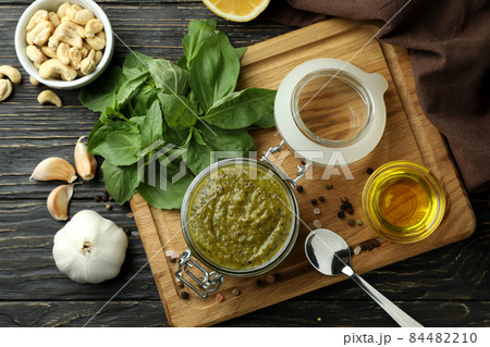 Pesto sauce and ingredients for cooking on wooden background Pesto sauce and ingredients for cooking on wooden background 84482210