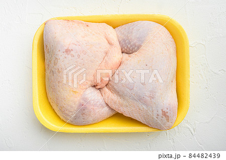 Fresh Chicken Whole Legs, in Foam Tray Pack, on white stone background, top view flat lay Fresh Chicken Whole Legs, in Foam Tray Pack, on white stone background, top view flat lay 84482439