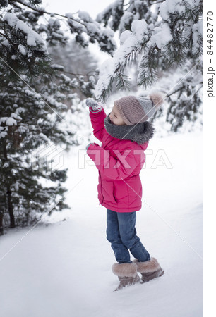 Child in winter. A little girl,  playing in the winter outside. 84482770