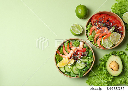 Tasty shrimp salad on green background, space for text Tasty shrimp salad on green background, space for text 84483385