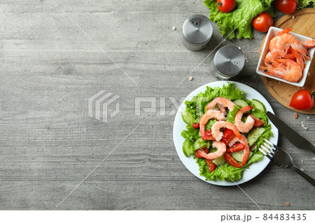 Concept of tasty eating with shrimp salad on gray wooden table Concept of tasty eating with shrimp salad on gray wooden table 84483435