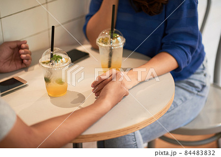 Holding Hands On Table Holding Hands On Table 84483832