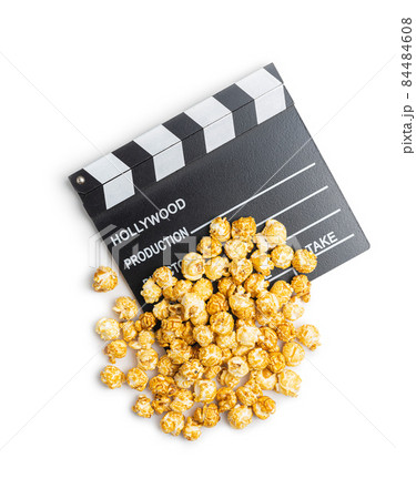 Sweet caramel popcorn and clapper board Sweet caramel popcorn and clapper board 84484608