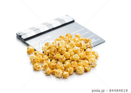 Sweet caramel popcorn and clapper board Sweet caramel popcorn and clapper board 84484619