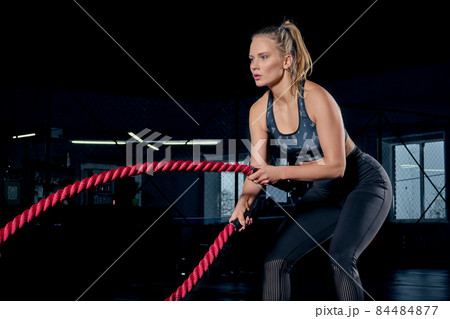 Attractive young fit and toned sportswoman working out in fitness training gym Attractive young fit and toned sportswoman working out in fitness training gym 84484877