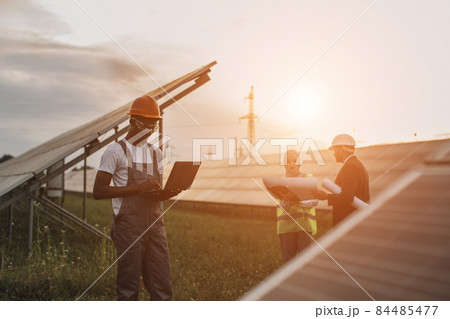 African american technician using laptop at solar station 84485477