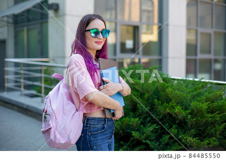 Portrait beautiful female writer dressed in casual outfit holding modern laptop in hand with backpack. 84485550