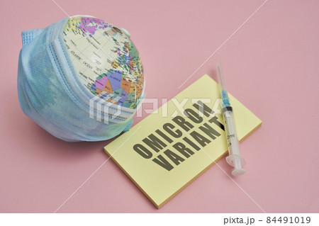 Globe in face mask and syringe. New vaccine against Covid-19 Omicron variant. Symbol of global roll-out new generation of vaccine against Omicron strain of coronavirus. Omicron variant vaccine 84491019