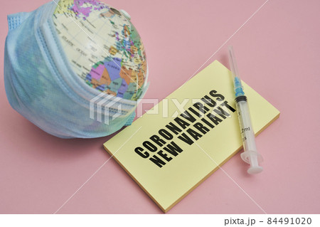 Globe in face mask and syringe. New vaccine against Covid-19 Omicron variant. Symbol of global roll-out new generation of vaccine against Omicron strain of coronavirus. Omicron variant vaccine 84491020