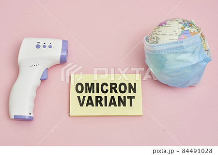 Miniature world globe with face mask and infrared thermometer. New coronavirus Omicron variant. Covid-19 omicron strain from South Africa. Symbol of global pandemic, suffering global economy Miniature world globe with face mask and infrared thermometer. New coronavirus Omicron variant. Covid-19 omicron strain from South Africa. Symbol of global pandemic, suffering global economy 84491028