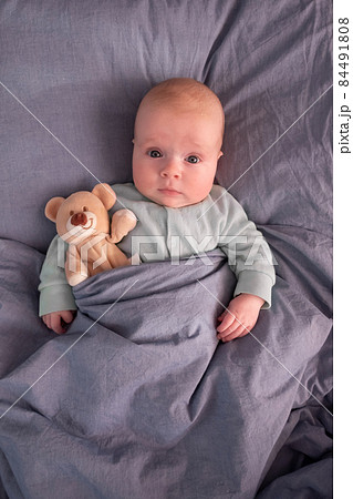 Funny caucasian baby lying on the bed. Funny caucasian baby lying on the bed. 84491808