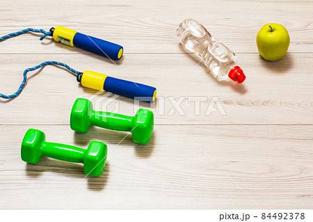 Various tools for fitness on floor in room. 84492378