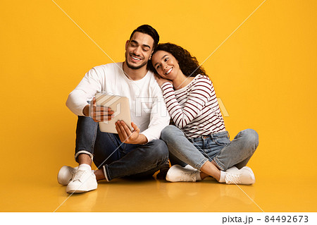 Online Entertainment. Happy Young Middle Eastern Couple Using Digital Tablet Together 84492673