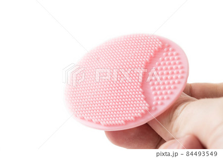 Cosmetic facial brush in hand on a white background, isolate. Copy space for text, dermatology Cosmetic facial brush in hand on a white background, isolate. Copy space for text, dermatology 84493549