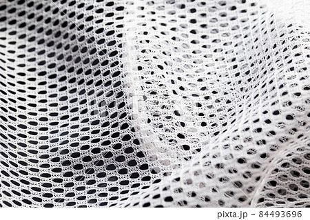 White lining in clothes in a hole, macro. Textured White lining in clothes in a hole, macro. Textured 84493696