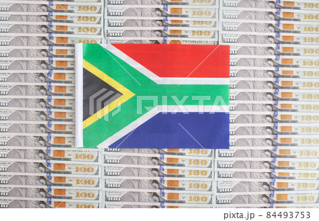 South Africa flag on a background from dollar banknotes. Concept of the relationship of the South Africa money in relation to the dollar, the country's economy, financial 84493753